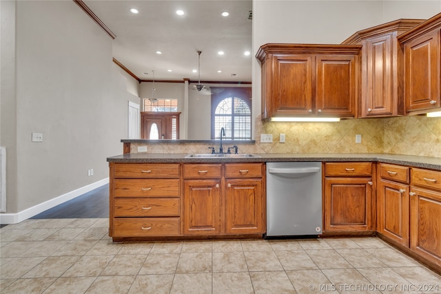 kitchen featuring hanging light fixtures, ornamental molding, sink, tasteful backsplash, and dishwasher