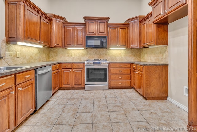 kitchen featuring backsplash, light tile floors, and stainless steel appliances