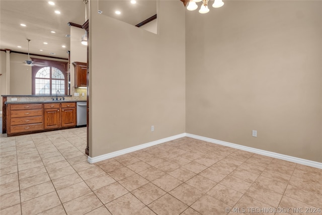 kitchen with ceiling fan, dishwasher, tasteful backsplash, sink, and light tile floors