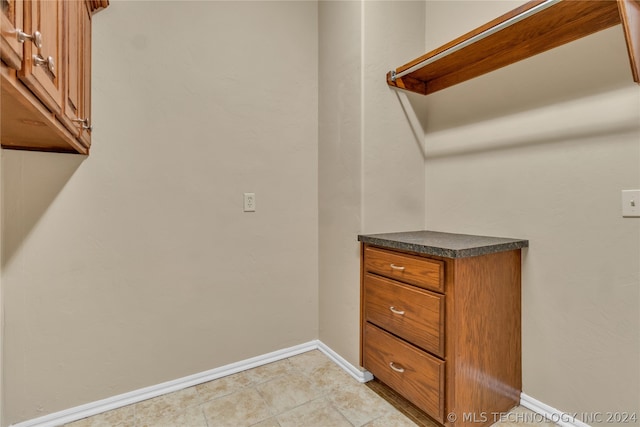 spacious closet featuring light tile flooring