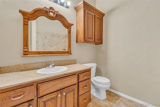 bathroom with vanity, toilet, and tile flooring