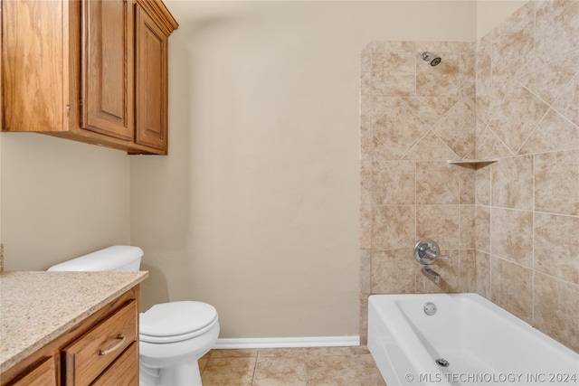 full bathroom featuring tile floors, tiled shower / bath, vanity, and toilet