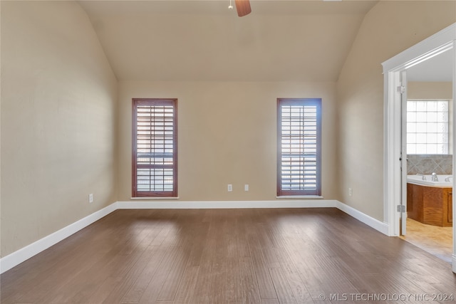 unfurnished room featuring lofted ceiling, ceiling fan, and tile floors