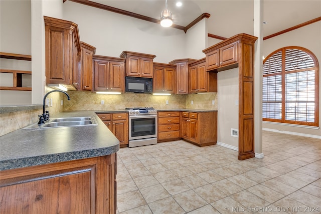 kitchen featuring crown molding, a high ceiling, backsplash, sink, and stainless steel range with gas cooktop