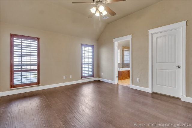 empty room with hardwood / wood-style flooring, ceiling fan, and lofted ceiling