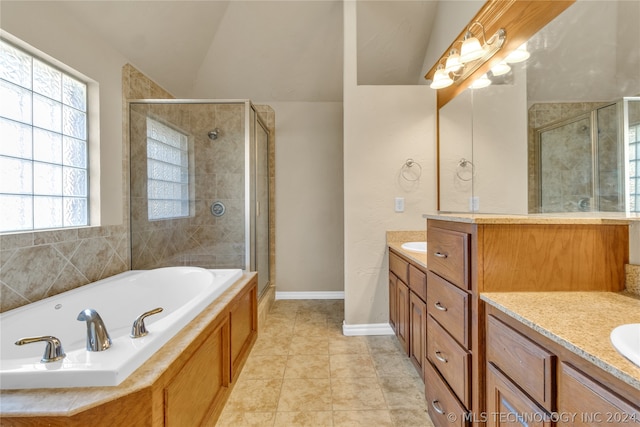 bathroom with lofted ceiling, large vanity, shower with separate bathtub, and tile flooring