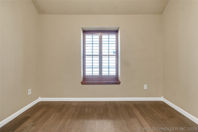 spare room featuring dark hardwood / wood-style flooring