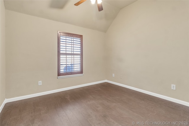 spare room with ceiling fan, dark hardwood / wood-style floors, and vaulted ceiling