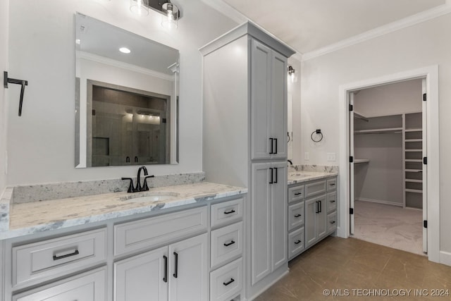 bathroom featuring vanity, ornamental molding, a shower with shower door, and tile patterned flooring