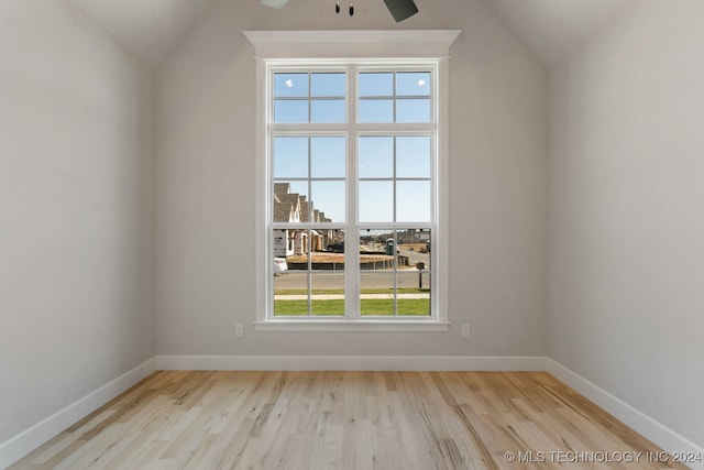 unfurnished room with vaulted ceiling, light hardwood / wood-style flooring, and ceiling fan