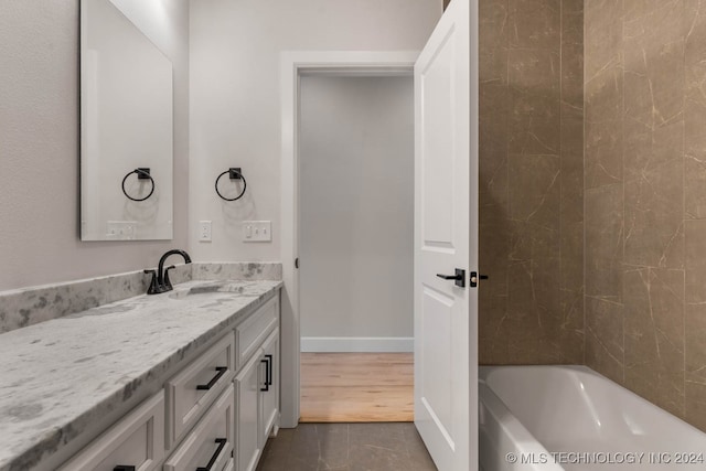 bathroom featuring a bathtub, hardwood / wood-style floors, and vanity