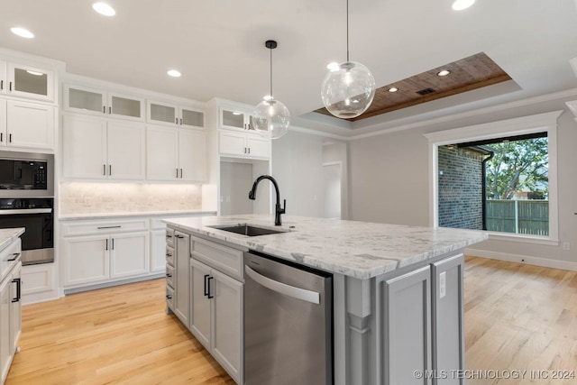 kitchen with a center island with sink, appliances with stainless steel finishes, and white cabinetry