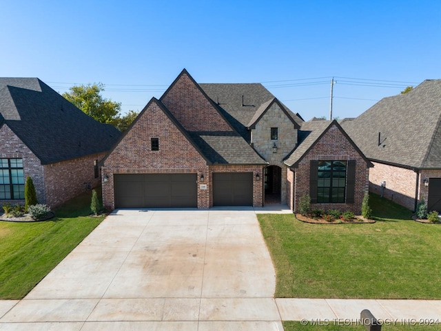 view of front of property with a garage and a front lawn