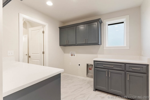 washroom featuring hookup for an electric dryer, cabinets, and hookup for a washing machine