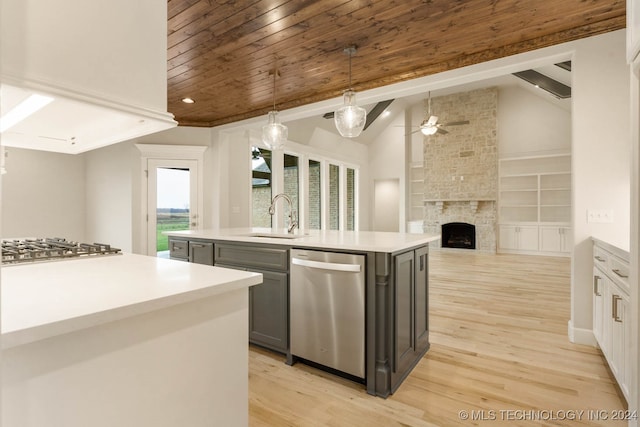 kitchen with hanging light fixtures, stainless steel appliances, an island with sink, lofted ceiling, and gray cabinets