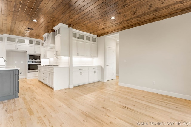 kitchen with stainless steel appliances, white cabinetry, light hardwood / wood-style floors, and wood ceiling