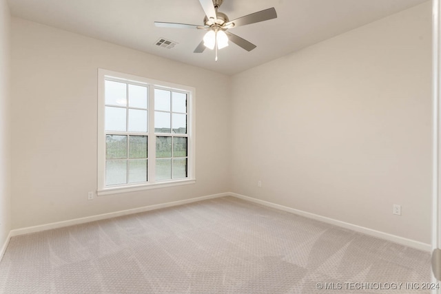 spare room featuring ceiling fan and carpet