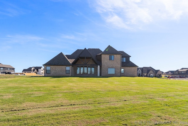 back of property featuring a lawn