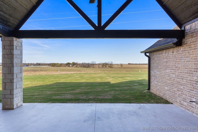 view of yard featuring a rural view and a patio