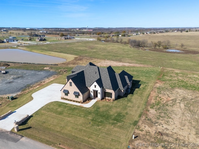 drone / aerial view featuring a rural view and a water view