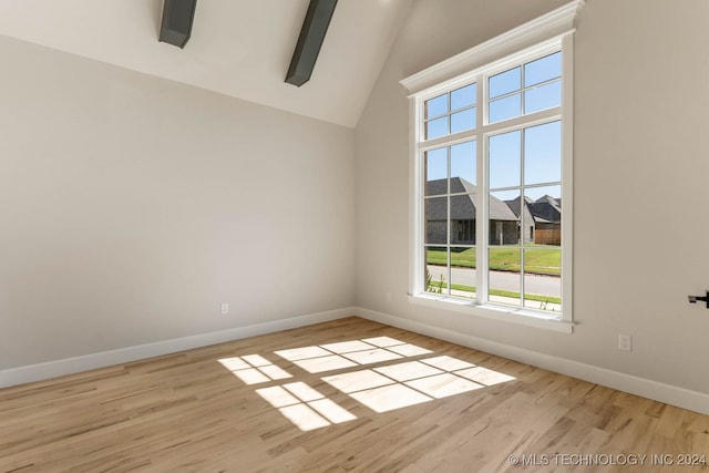 unfurnished room with vaulted ceiling and light hardwood / wood-style floors