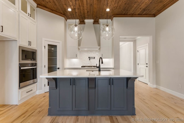 kitchen with white cabinets, light hardwood / wood-style flooring, appliances with stainless steel finishes, wooden ceiling, and premium range hood