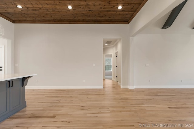 spare room with wood ceiling, light hardwood / wood-style floors, and ornamental molding