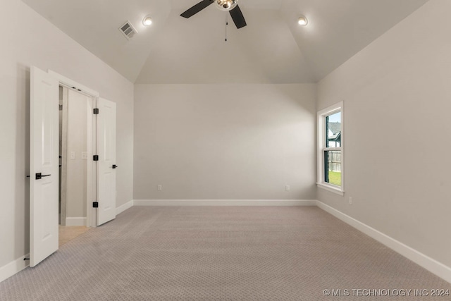 unfurnished bedroom with lofted ceiling, light carpet, and ceiling fan