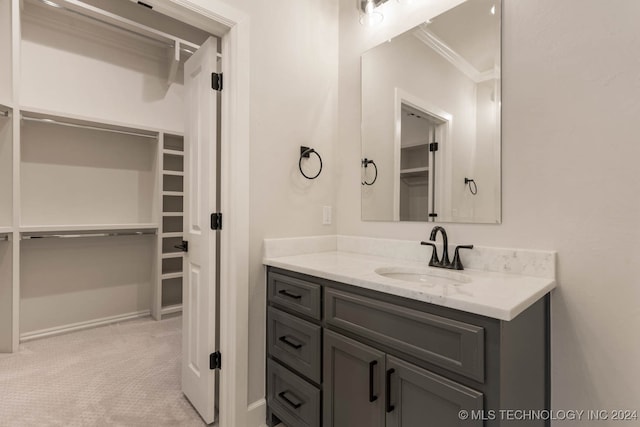 bathroom with ornamental molding and vanity