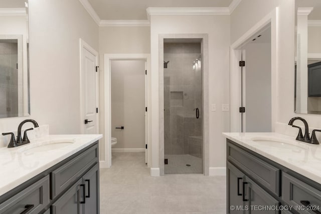 bathroom featuring ornamental molding, vanity, a shower with shower door, and toilet