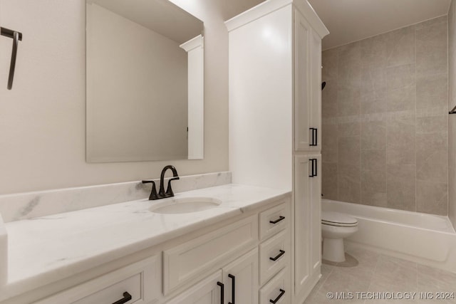 full bathroom featuring tiled shower / bath, vanity, toilet, and tile patterned floors