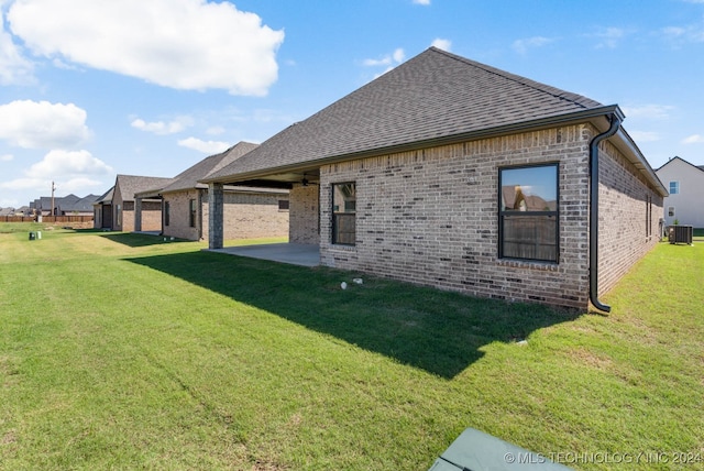 view of home's exterior featuring a lawn, a patio, and central AC