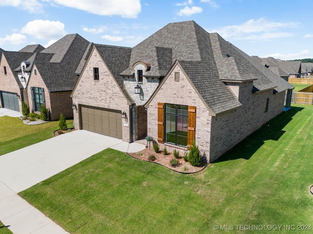 view of front of house featuring a garage and a front lawn