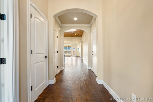 hall featuring crown molding and dark wood-type flooring