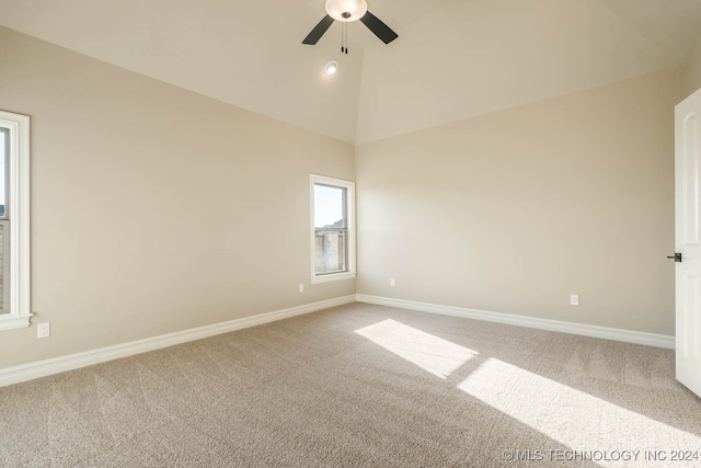 spare room with carpet floors, ceiling fan, and high vaulted ceiling