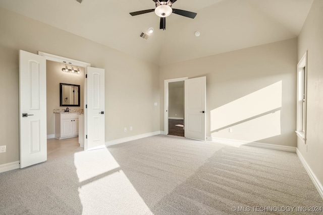 carpeted bedroom featuring vaulted ceiling, ceiling fan, and ensuite bathroom