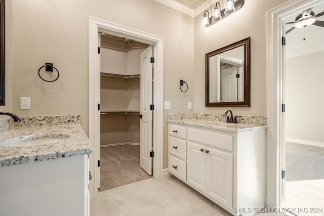 bathroom with ceiling fan, vanity, crown molding, and tile patterned floors