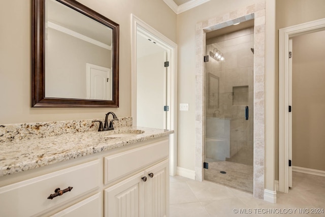 bathroom with crown molding, vanity, tile patterned floors, and a shower with shower door