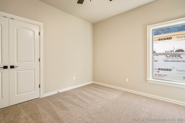 spare room featuring carpet floors and ceiling fan