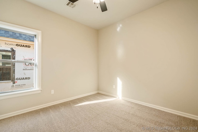 empty room with carpet floors, a healthy amount of sunlight, and ceiling fan