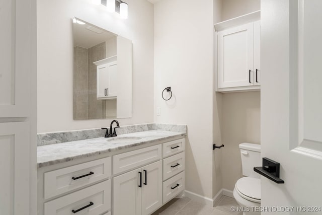 bathroom with vanity, toilet, and tile patterned flooring