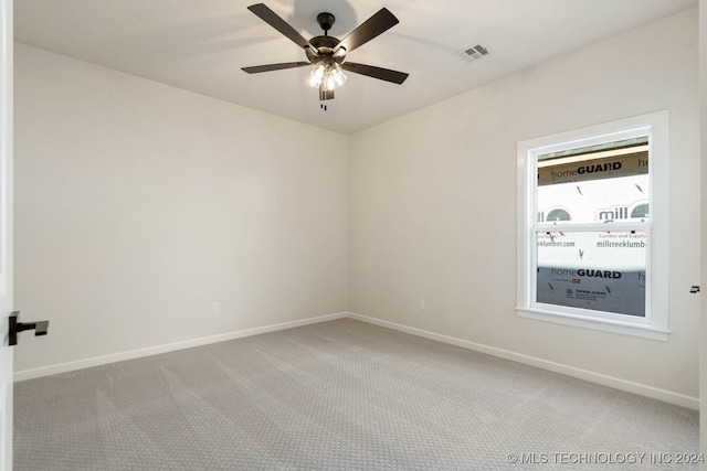 empty room with ceiling fan and carpet