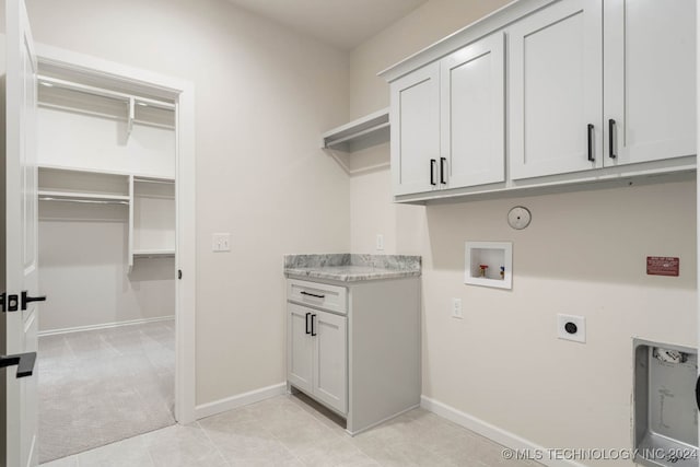 washroom with cabinets, hookup for a washing machine, light carpet, and electric dryer hookup