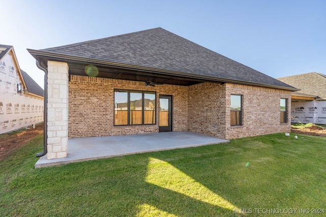 back of property featuring a patio and a lawn