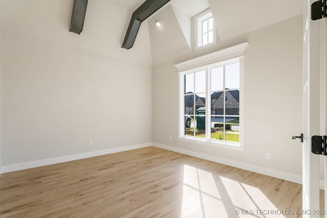 interior space with light hardwood / wood-style floors, high vaulted ceiling, and beamed ceiling