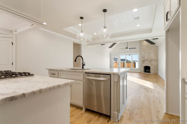 kitchen with light hardwood / wood-style floors, white cabinetry, light stone countertops, and stainless steel appliances