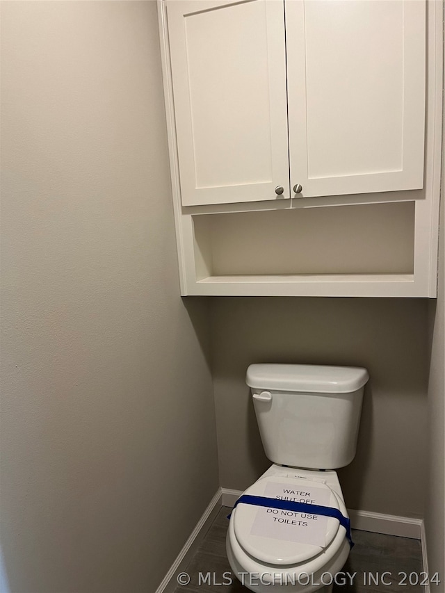 bathroom with tile flooring and toilet