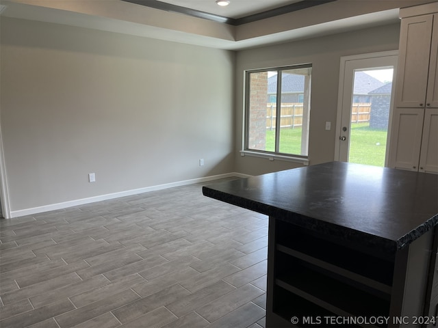 kitchen featuring a center island, light hardwood / wood-style flooring, and white cabinets