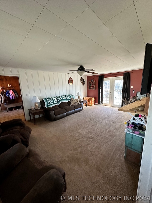 carpeted living room with french doors and ceiling fan