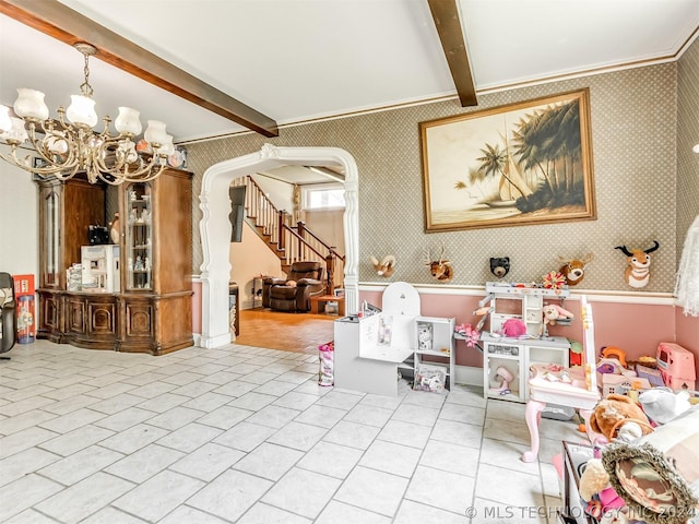 recreation room featuring a notable chandelier, beam ceiling, light tile flooring, and crown molding